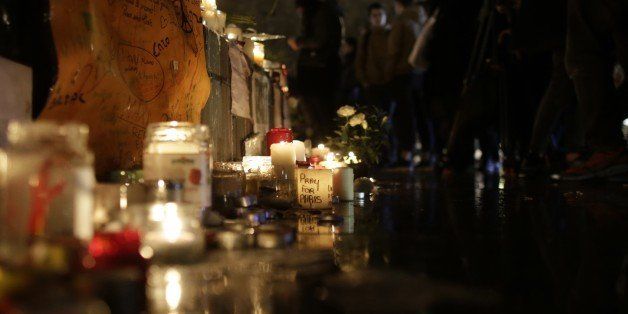 People light candles and place flowers at a makeshift memorial for the victims of a series of deadly attacks in Paris, at the Place de la Republique in Paris on November 20, 2015. Gunmen and suicide bombers went on a killing spree in Paris on November 13, attacking the concert hall Bataclan as well as bars, restaurants and the Stade de France. Islamic State jihadists operating out of Iraq and Syria released a statement claiming responsibility for the coordinated attacks that killed 130 and injured over 350. AFP PHOTO / KENZO TRIBOUILLARD (Photo credit should read KENZO TRIBOUILLARD/AFP/Getty Images)