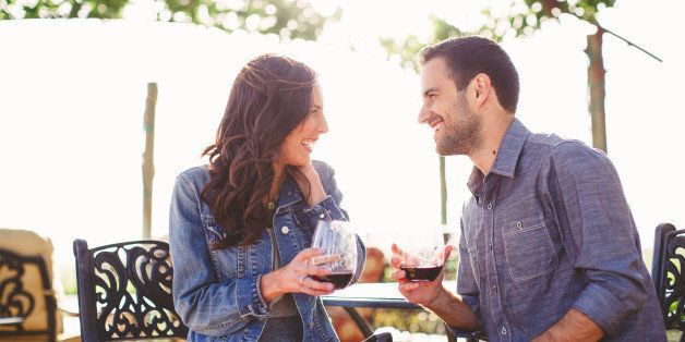 Couple enjoy glasses of wine at outdoor bar