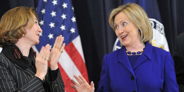 US Secretary of State Hillary Rodham Clinton (R) arrives for a town hall meeting with Department of State employees to discus