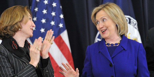 US Secretary of State Hillary Rodham Clinton (R) arrives for a town hall meeting with Department of State employees to discuss the release of the first Quadrennial Diplomacy and Development Review, ÂLeading Through Civilian Power,Â December 15, 2010 at the State Department in Washington,DC. Standing with Secretary Clinton is Director of Policy Planning Anne-Marie Slaughter. AFP PHOTO/Karen BLEIER (Photo credit should read KAREN BLEIER/AFP/Getty Images)