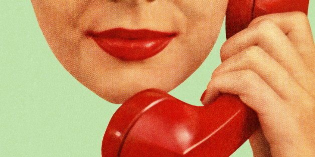 Woman Holding Red Phone to Hear Ear