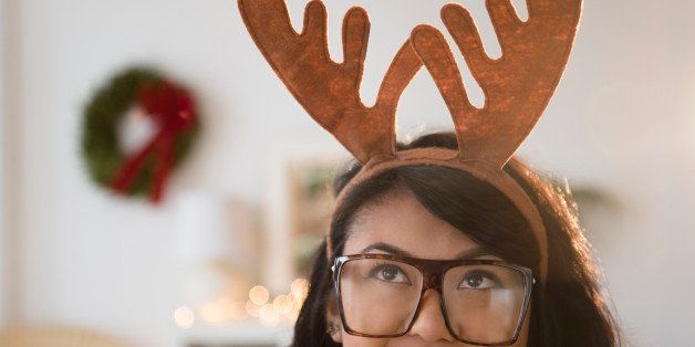 Pacific Islander woman wearing Christmas reindeer horns