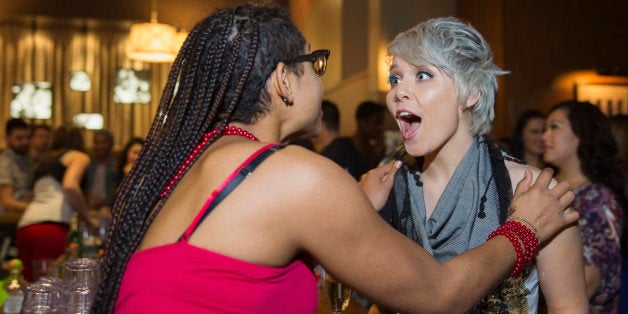 Surprised woman talking to friend in bar