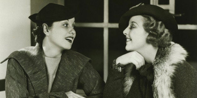 Two young women chatting, having coffee and cake, (B&W)