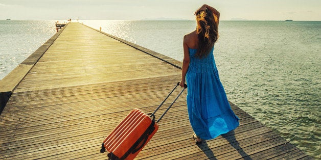 young woman with suitcase...