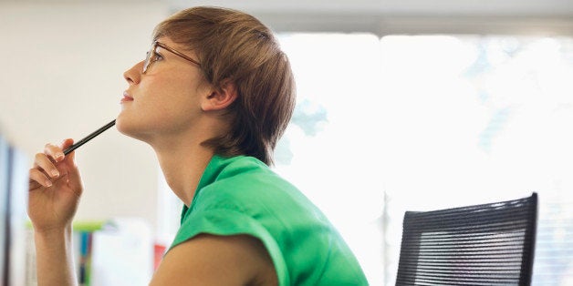 Businesswoman thinking at desk