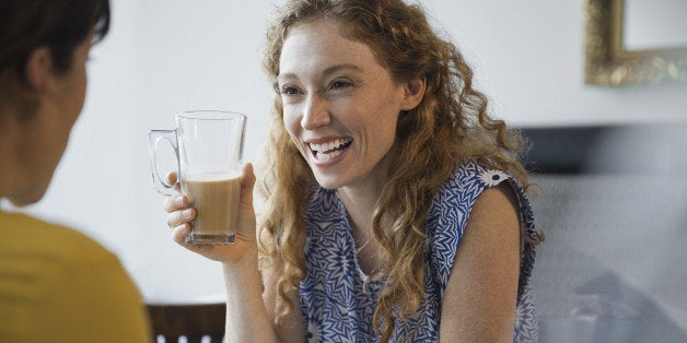 Female friends laughing at restaurant table