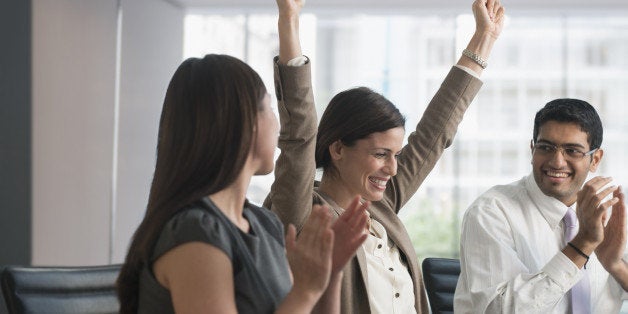 Business people cheering in meeting