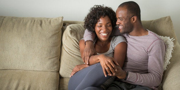 Portrait of mid adult couple sitting on sofa