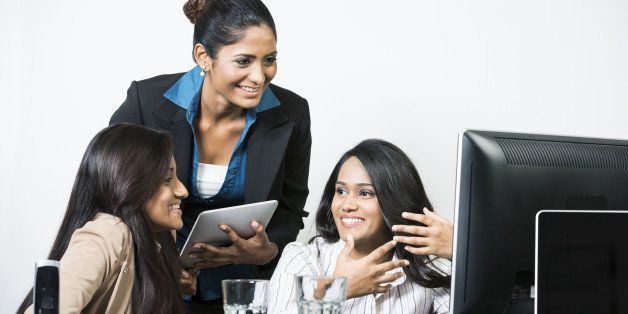 Group of happy Indian business women in a meeting at the office.