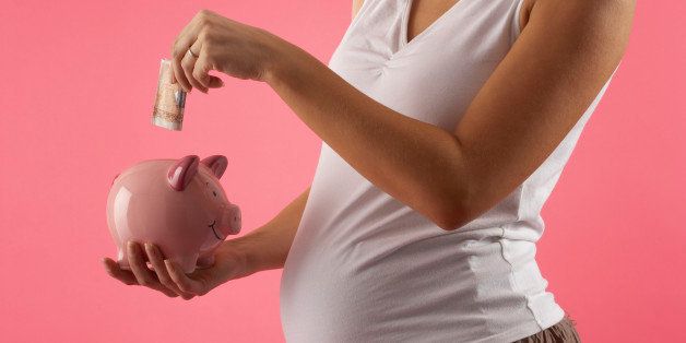 Pregnant Woman Saving Money in Piggy Bank