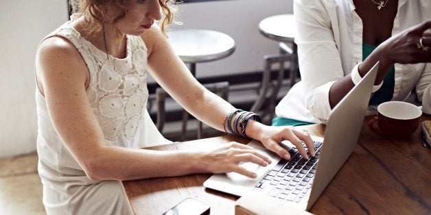 Woman using laptop in cafe