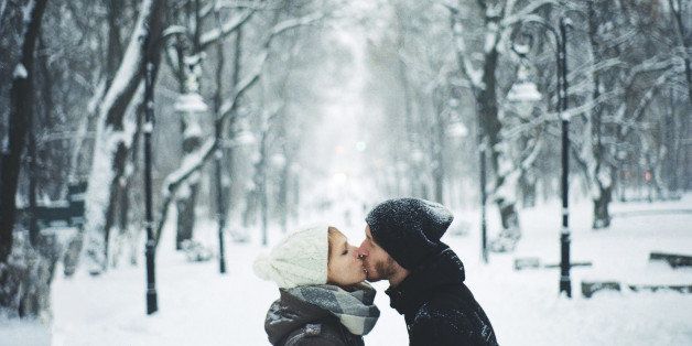 Couple kissing under the snow.