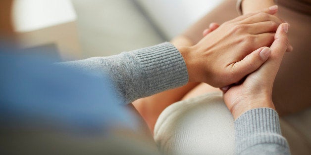 Close-up of psychiatrist hands together holding palm of her patient