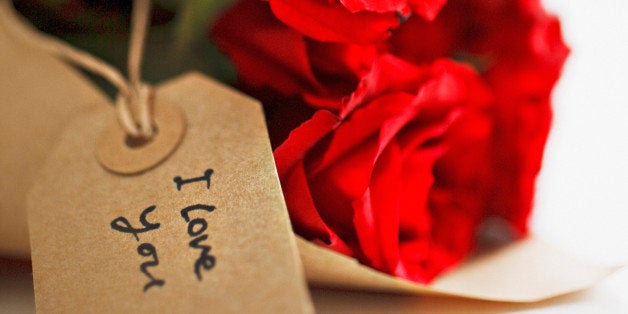 Close up of red roses with gift tag