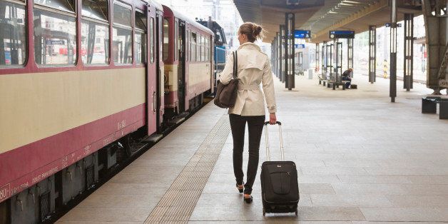 Woman with suitcase in a train station