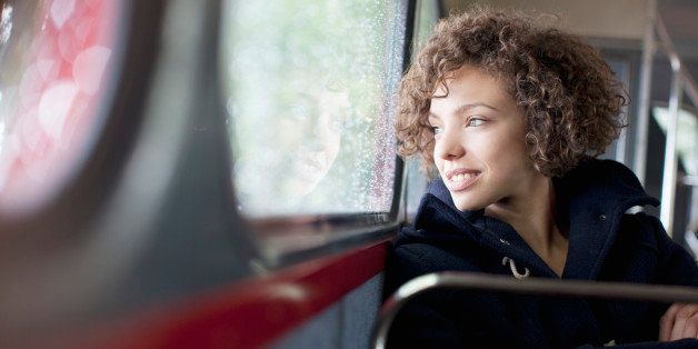 Smiling woman riding bus