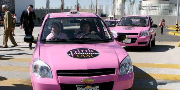 TO GO WITH AFP STORY - A female taxi driver powers her 'Pink Taxi' --to be used exclusively by women-- in Puebla, on October