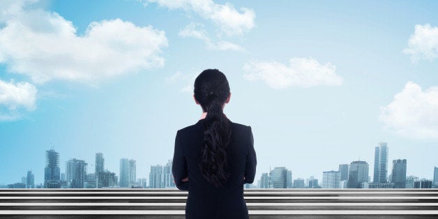 Back view of asian business woman looking the city