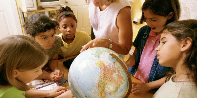 Teacher and students with a globe