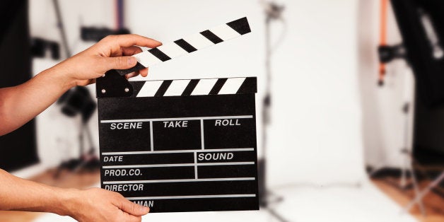 Man hands holding film clapper. Blur film studio on background