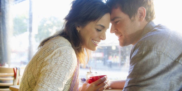 Couple holding hands in cafe