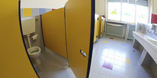 Yellow door opened into bathrooms with sinks of a nursery