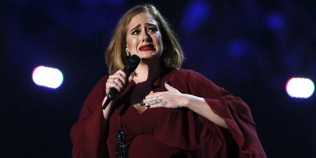 Adele reacts as she accepts the global success award at the BRIT Awards at the O2 arena in London, February 24, 2016. REUTERS/Stefan Wermuth EDITORIAL USE ONLY