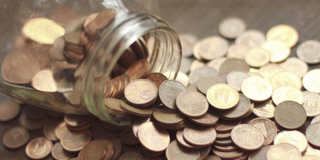 Table full of euro coins from a glass jar