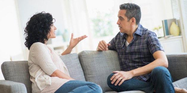 USA, New Jersey, Jersey City, Couple talking on sofa