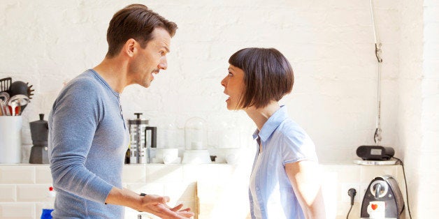 adult heterosexual couple quarreling at home