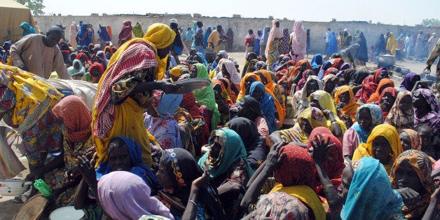 Internally Displaced Persons (IDP) mostly women and children sit waiting to be served with food at Dikwa Camp, in Borno State in north-eastern Nigeria, on February 2, 2016.The National Emergency Management Agency in collaboration with Borno State Emergency Management Agency has set up new IDP camps in Ngala, Marte, Bama and Mafa councils to decongest the growing population of IDP camp set up at Dikwa council of Borno State. Nigeria expects many of the 2.1 million people internally displaced by Boko Haram's insurgency to return home in the coming year, amid claims the Islamists are in disarray and a spent force. / AFP / STRINGER (Photo credit should read STRINGER/AFP/Getty Images)