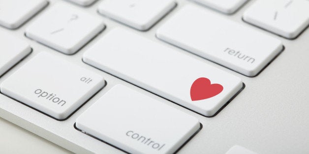 Keyboard with red heart on button, close-up