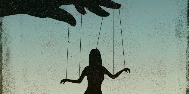 A silhouetted woman being controlled by a puppeteer