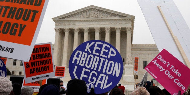 Pro-abortion rights signs are seen during the March for Life 2016, in front of the U.S. Supreme Court, Friday, Jan. 22, 2016 in Washington, during the annual rally on the anniversary of 1973 'Roe v. Wade' U.S. Supreme Court decision legalizing abortion. (AP Photo/Alex Brandon)