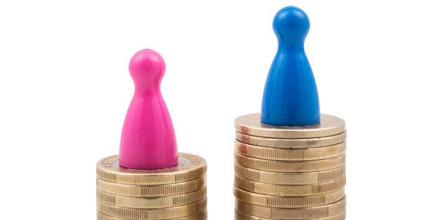 Pink and blue figures on different coin stacks. Concept for gender pay gap.