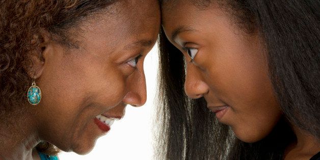 African American female teen head to head with mom