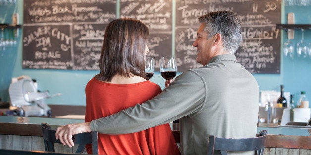 Couple drinking wine together at bar