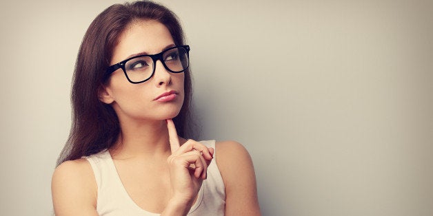 Serious fun thinking young woman looking up on empty copy space. Vintage portrait