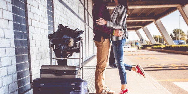 Young couple kissing outside airport