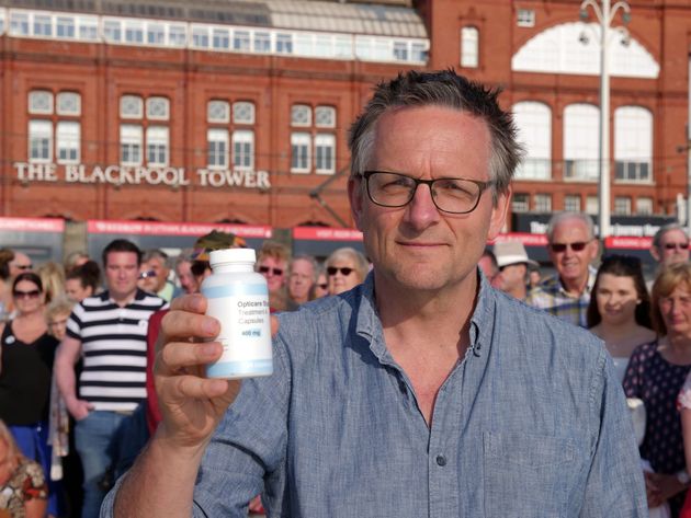 Michael Moseley holding a bottle of the placebo pills.