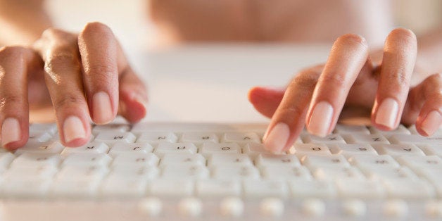 Cape Verdean woman typing on keyboard