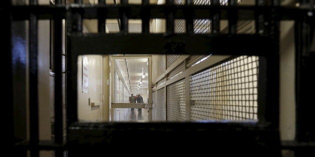 Members of the media walk down the corridor inside the Adjustment Center during a media tour of California's Death Row at San