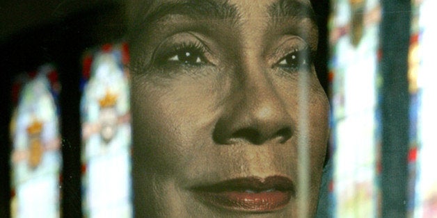 The stained glass windows of the Ebenezer Baptist Church are reflected in a portrait of Coretta Scott King during a memorial