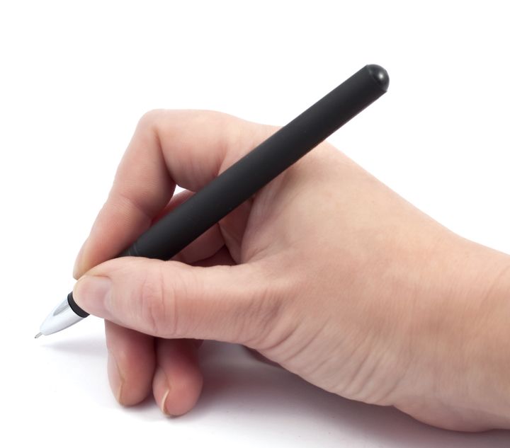 pen in hand on white background