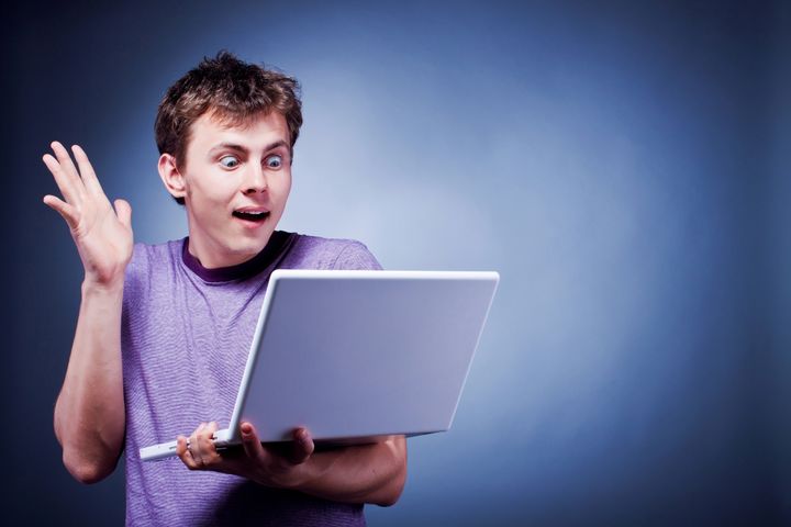 surprised happy man with laptop