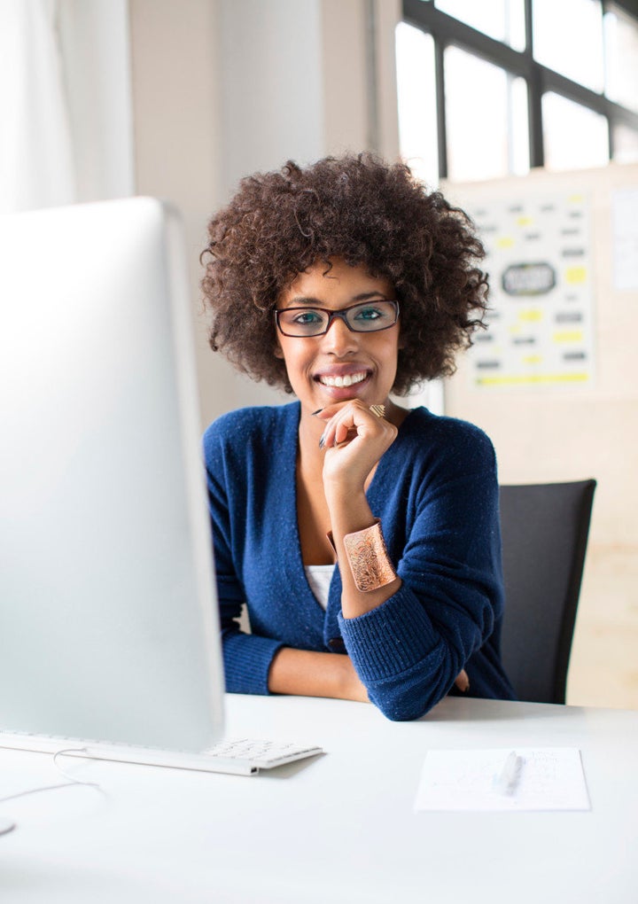 Picture of a young confident woman working at a start up. Perfect image representing women in the workplace