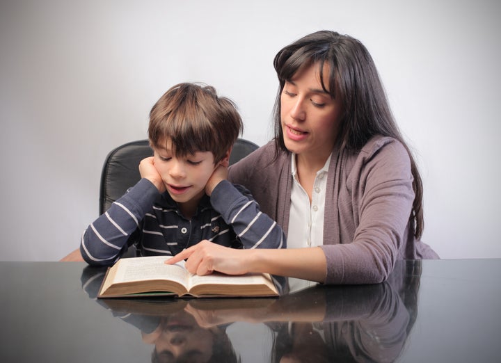 young woman teaching a child...