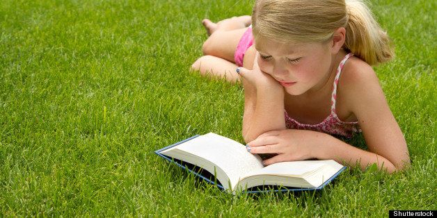 girl reading outdoors in the...
