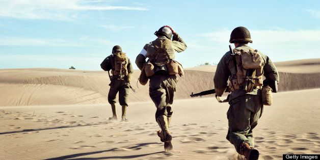 Three WWII Soldiers Running In The Desert Sand